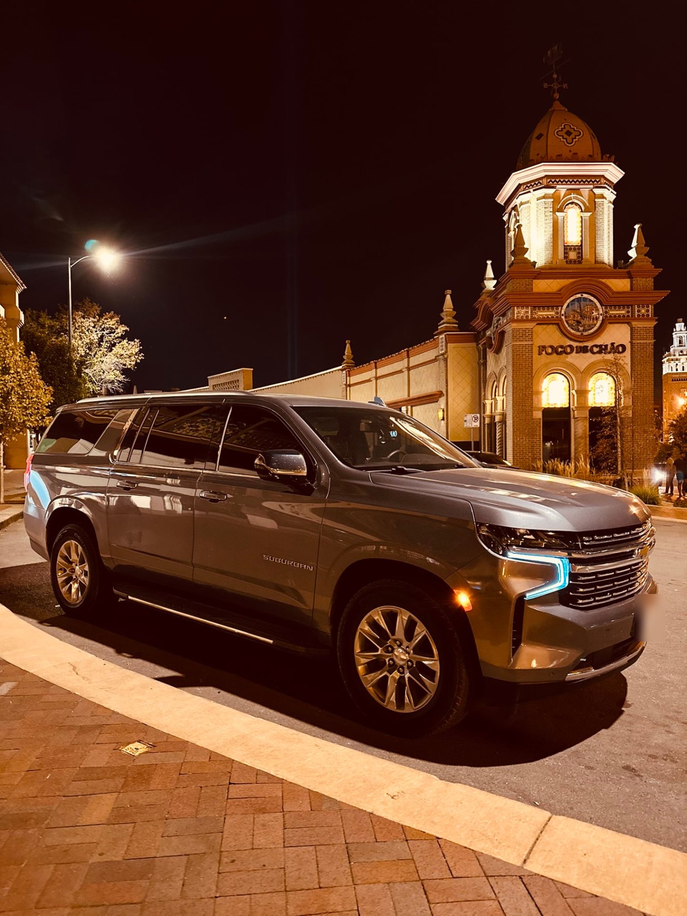Suburban parked on a plaza in the evening